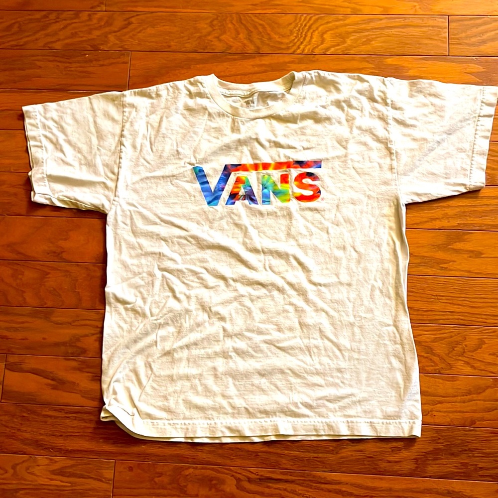 A Vans T-shirt that is white, and has a tie-dye vans logo in the front.